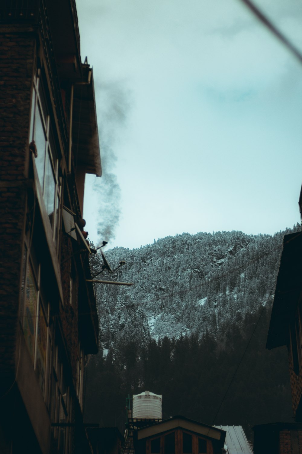 a view of a mountain from a narrow alley way