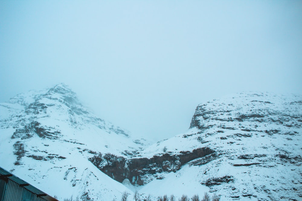 une montagne couverte de neige avec un bâtiment au premier plan