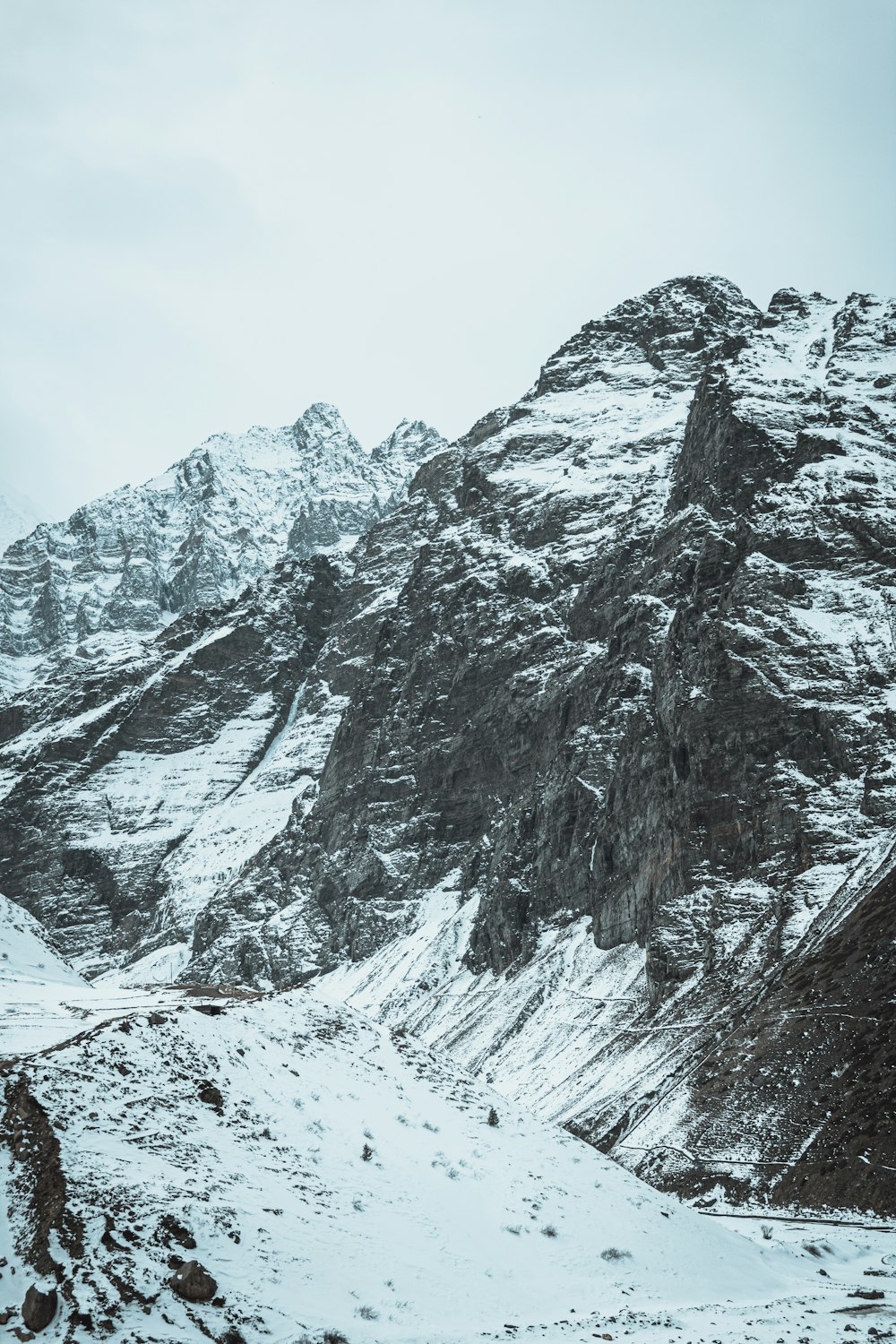 a snow covered mountain with a road going through it