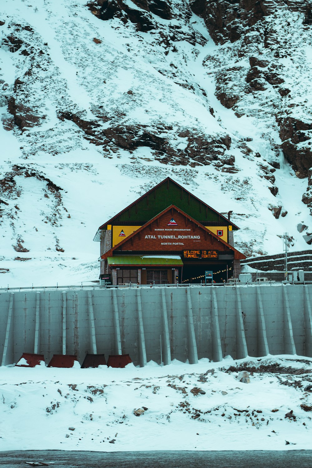 a snow covered mountain with a building on top of it