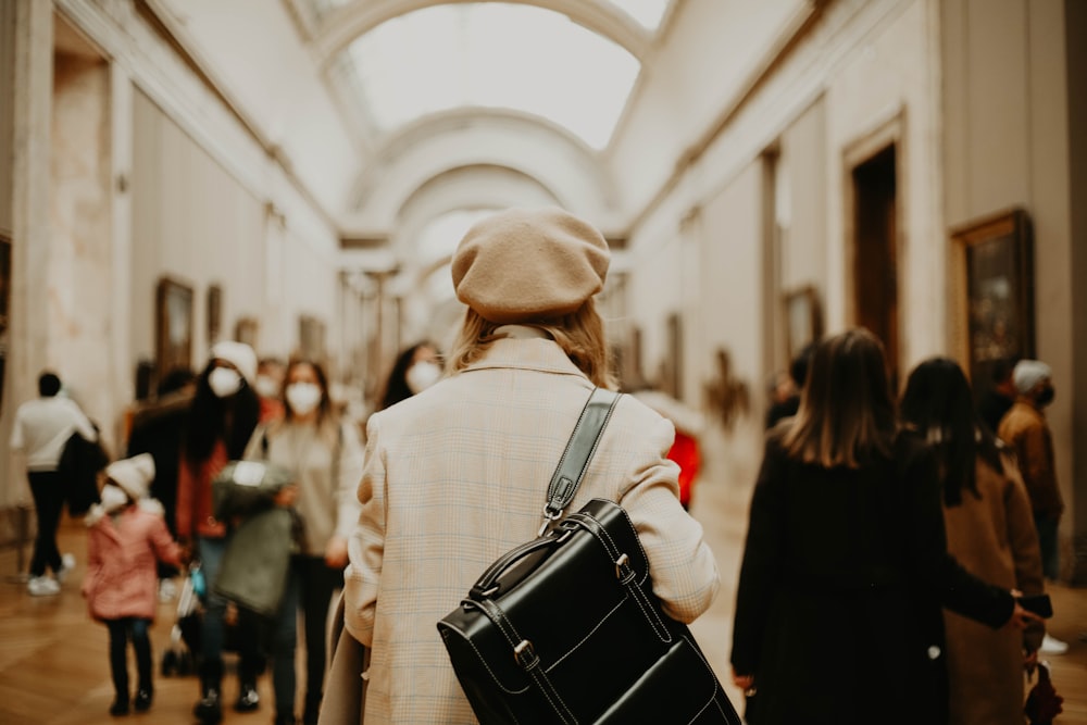 a group of people walking down a hallway