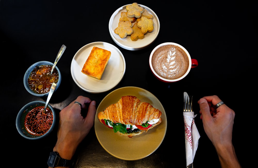 a person sitting at a table with a plate of food