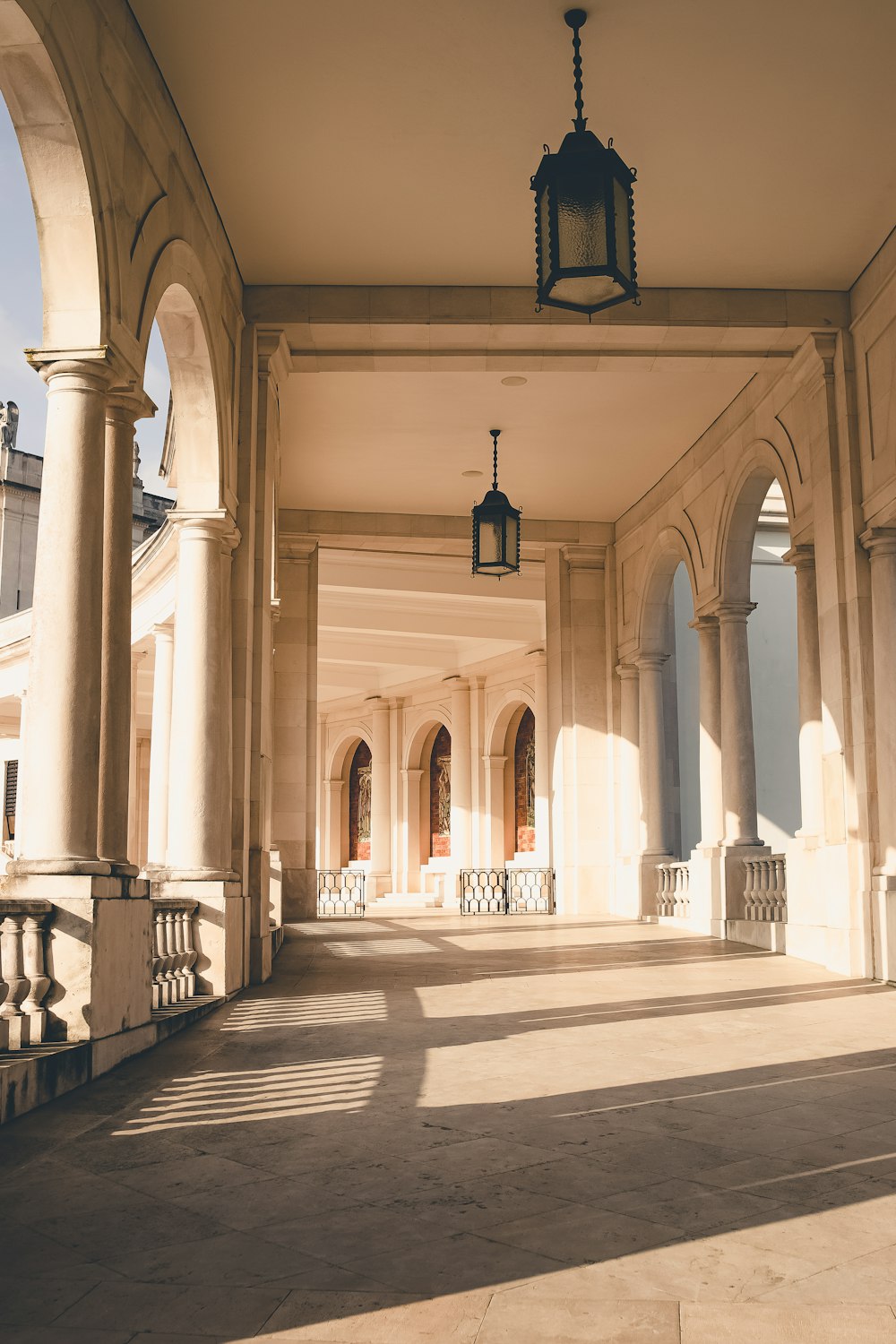 a large building with columns and a light hanging from the ceiling