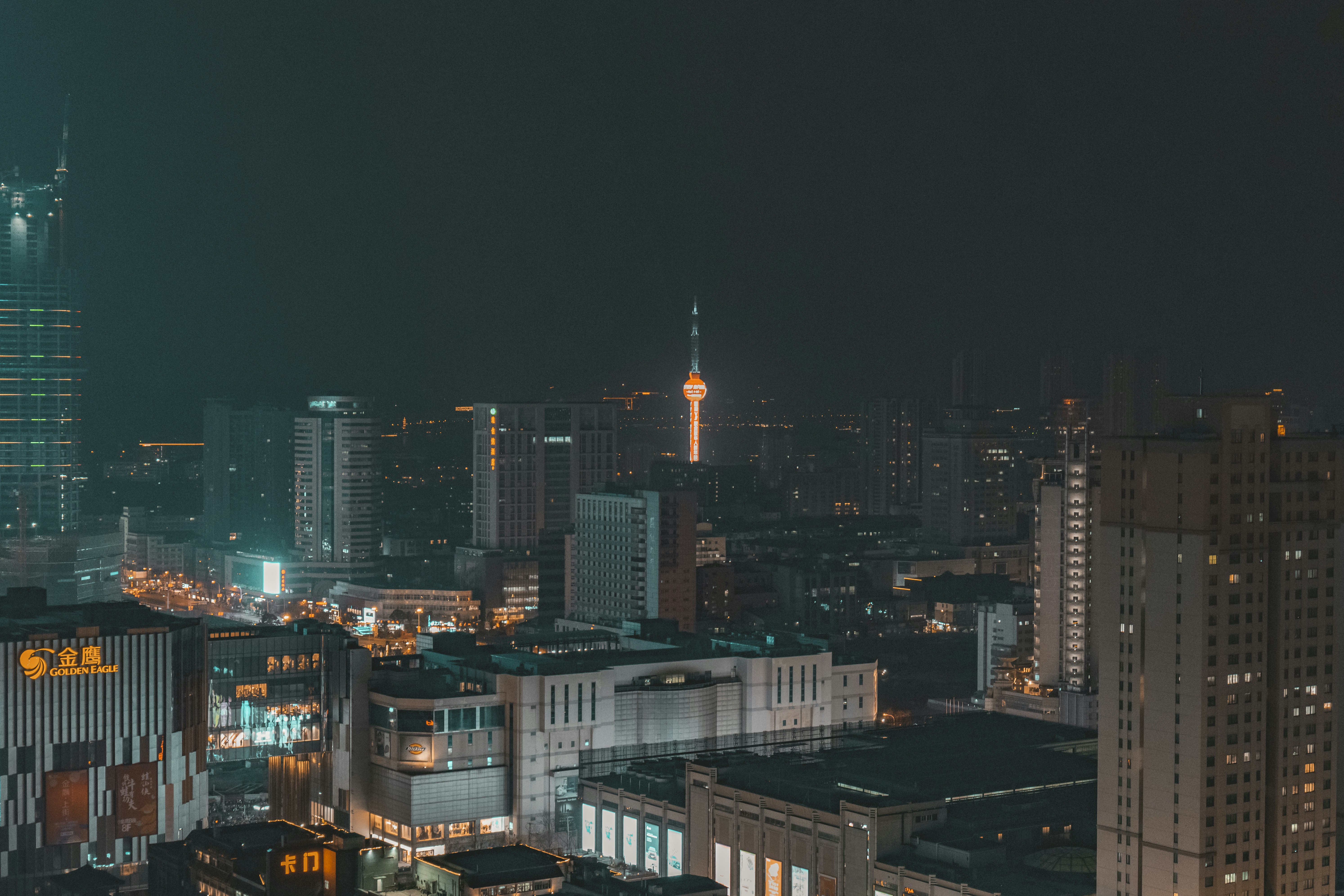 a view of a city at night from the top of a building