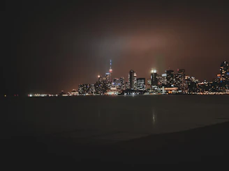 Abstract city skyline at night with subtle dark gradients and glowing gold highlights.