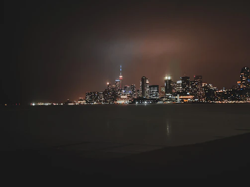 Abstract city skyline at night with subtle dark gradients and glowing gold highlights.