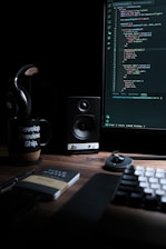 A developer working on custom software design on a laptop in an office setting