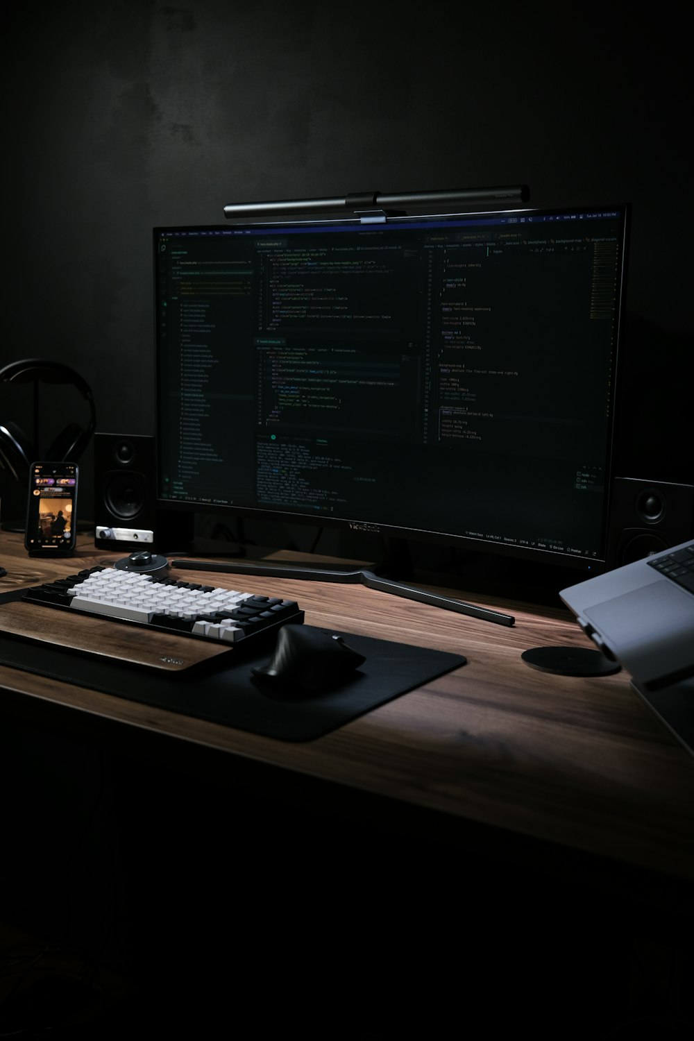 a computer monitor sitting on top of a wooden desk