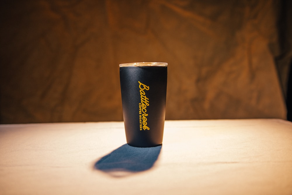 a black cup sitting on top of a table