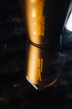 Close-up of a sleek stainless steel tumbler engraved with a custom name and design.