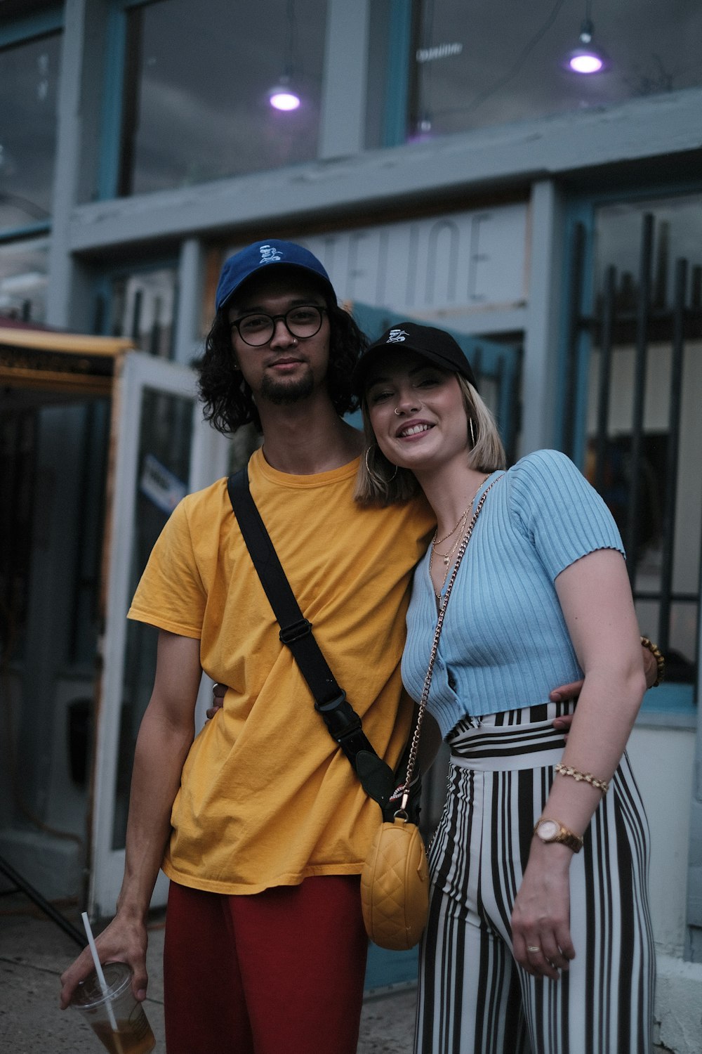 a man standing next to a woman in front of a building