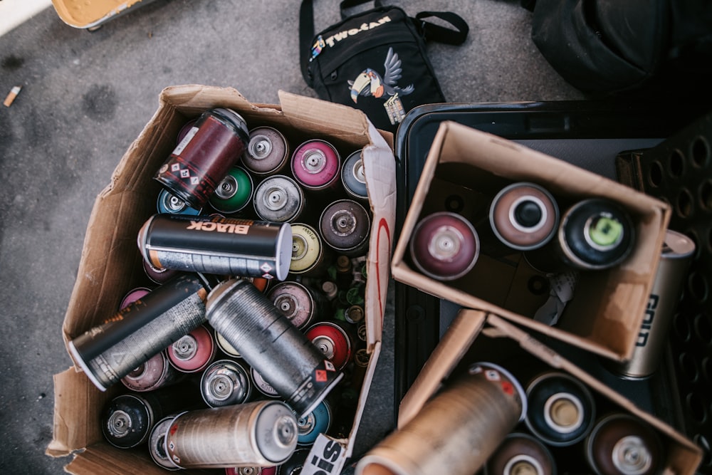 a couple of boxes filled with lots of different types of cans