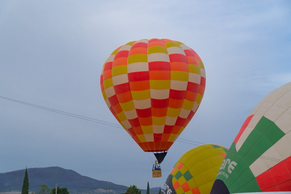 a group of hot air balloons flying in the sky