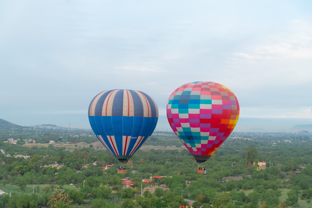 a couple of hot air balloons flying in the sky