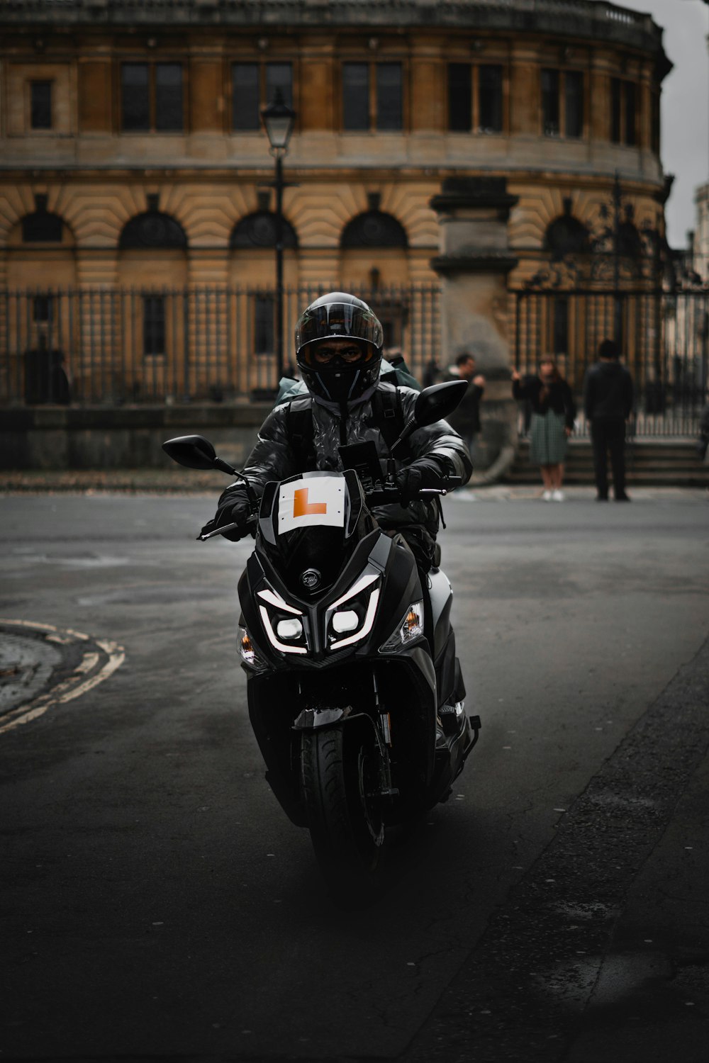 a person riding a motorcycle on a city street