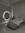 a bedroom with a marble wall and a round mirror