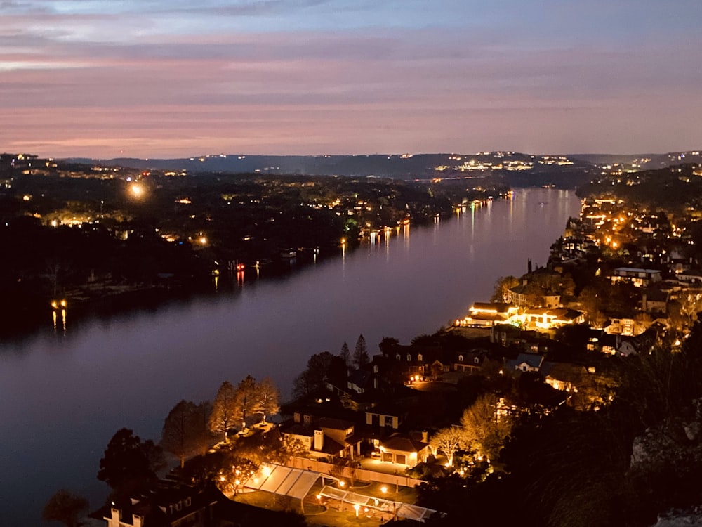 a night time view of a city and a river