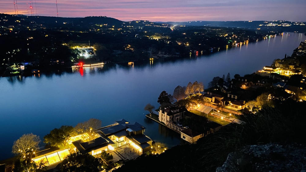 a view of a lake at night from a hill