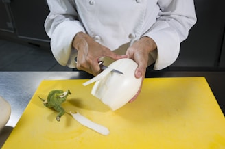 a person in a chef's coat is peeling an apple