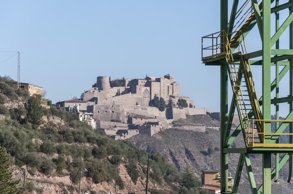 a castle on top of a hill near a river