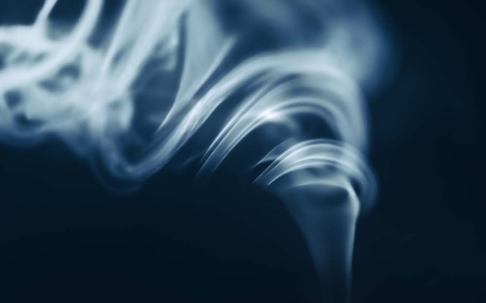 a blurry photo of a smokestack on a dark background