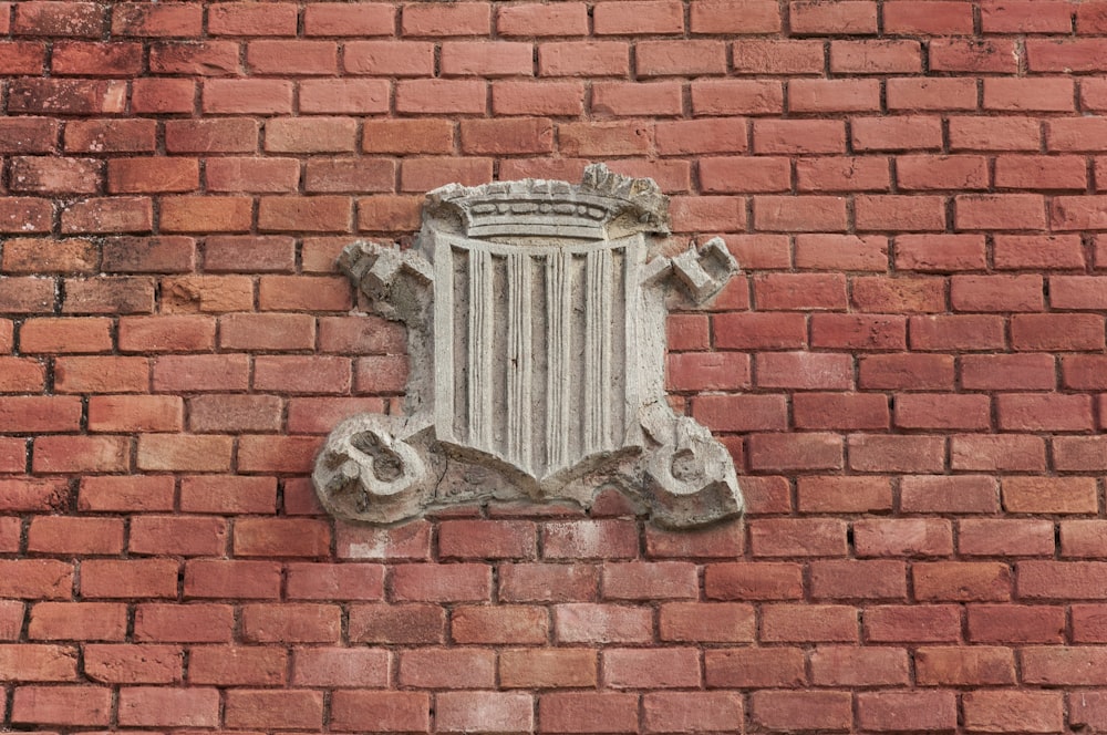 a brick wall with a decorative window on it