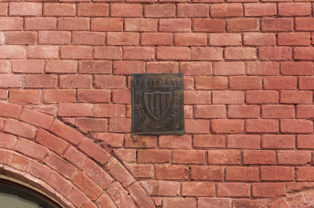 a brick wall with a plaque on it