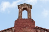 a brick tower with a clock on top of it