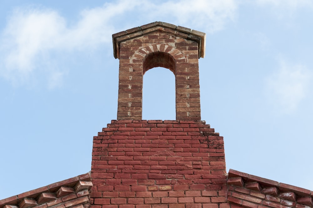 a brick tower with a clock on top of it