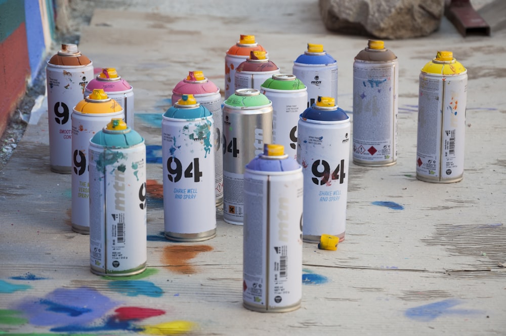 a group of spray paint cans sitting on the ground