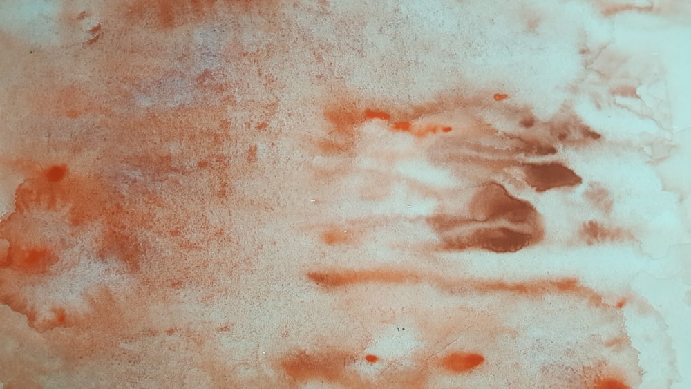 a close up of a red substance on a white surface