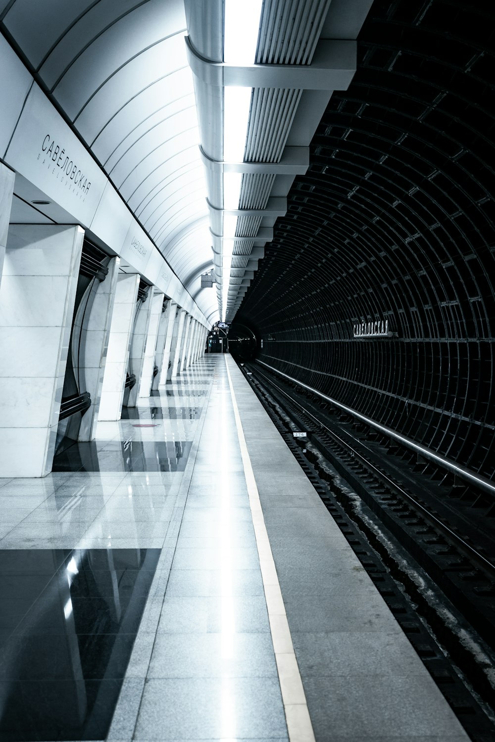 a black and white photo of a subway station