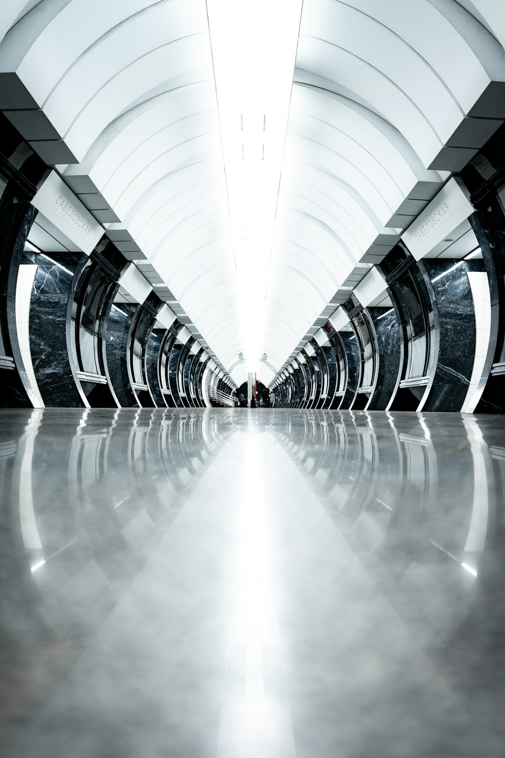 a long hallway with a white ceiling and white walls