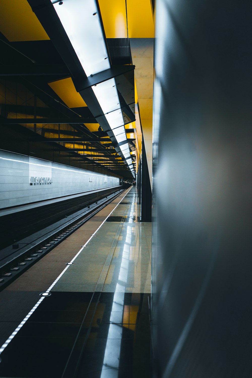 a subway station with a train on the tracks