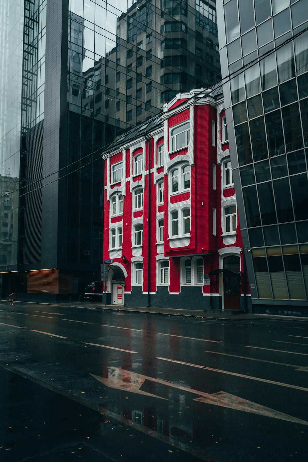 a red and white building in the middle of a city