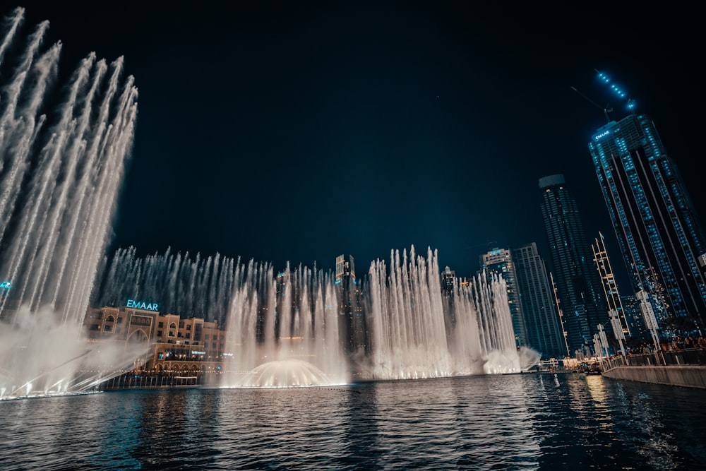 a large group of water fountains in the middle of a body of water
