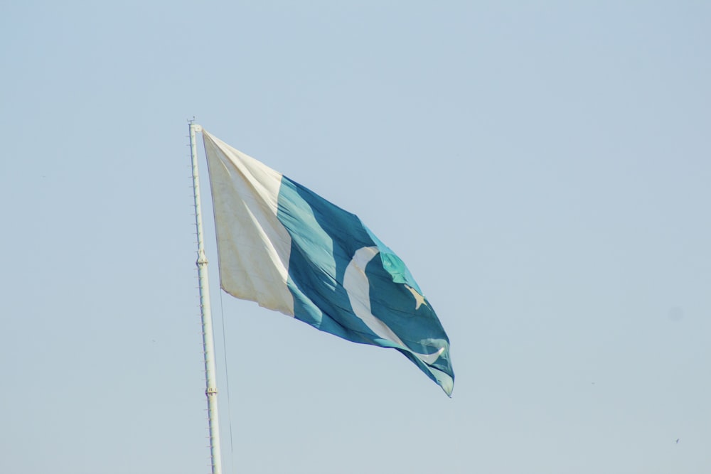 a blue and white flag flying in the wind