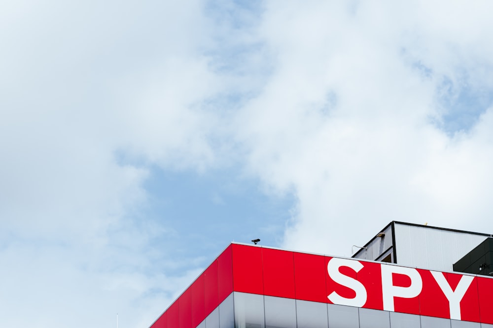 a red and white building with a sky background