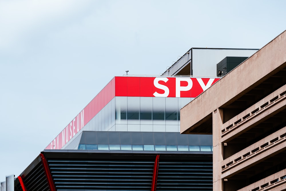 a red and white sign on top of a building