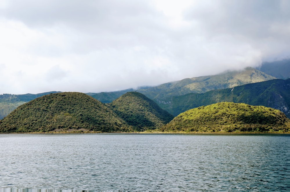 a body of water with mountains in the background