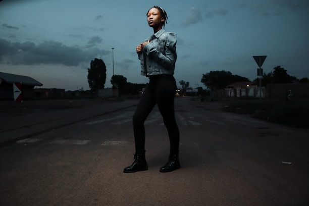 A vigilant security guard in uniform standing confidently outside a commercial building at dusk.