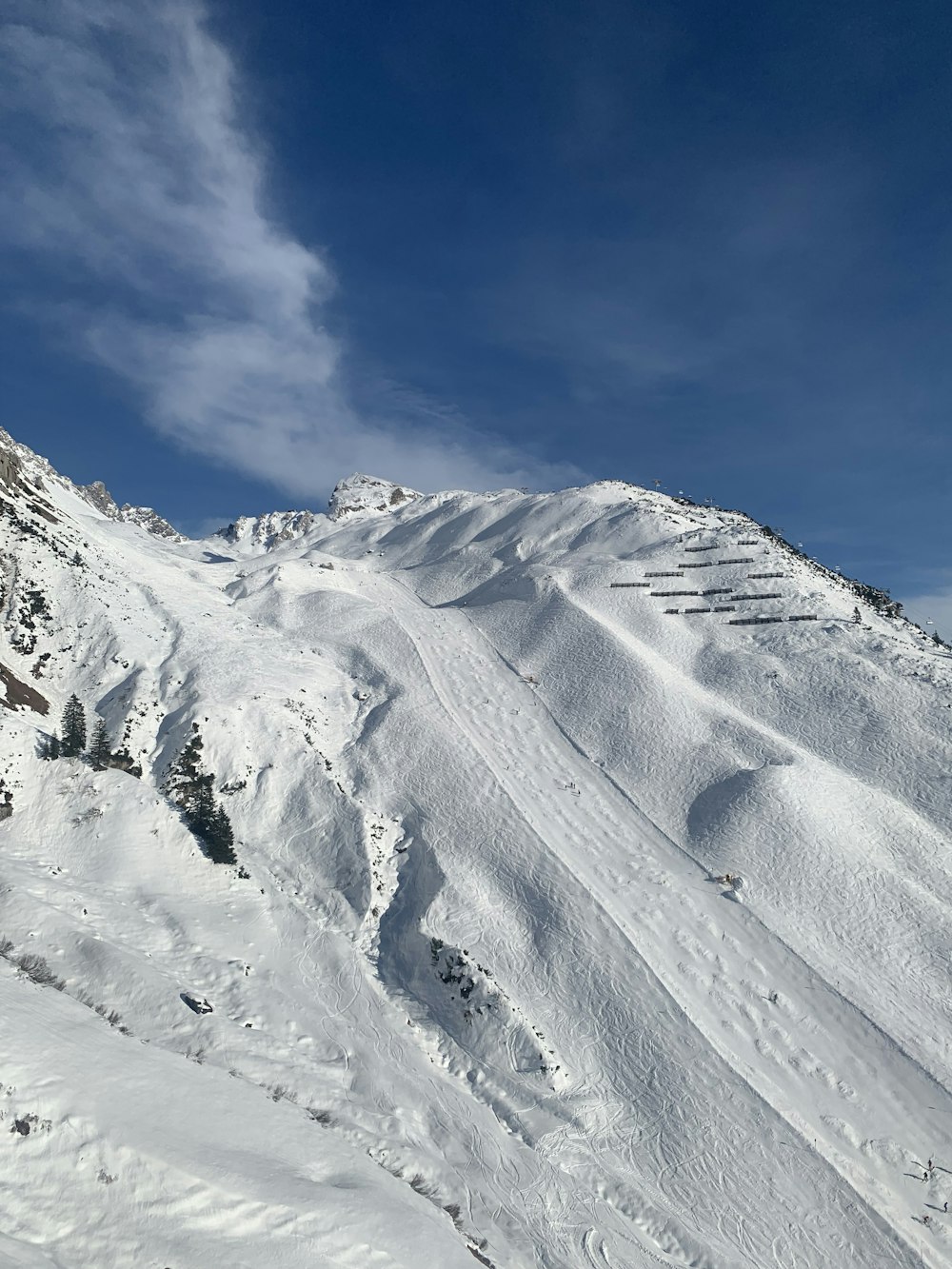 a man riding skis down the side of a snow covered slope