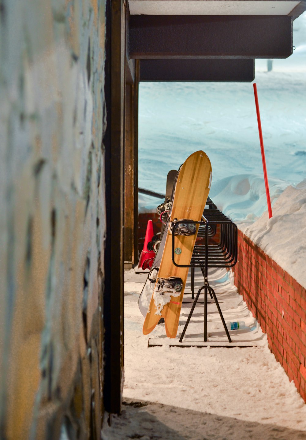 a surfboard is propped up against a wall