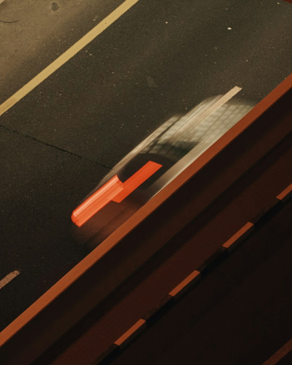 a car driving down a street next to a traffic light