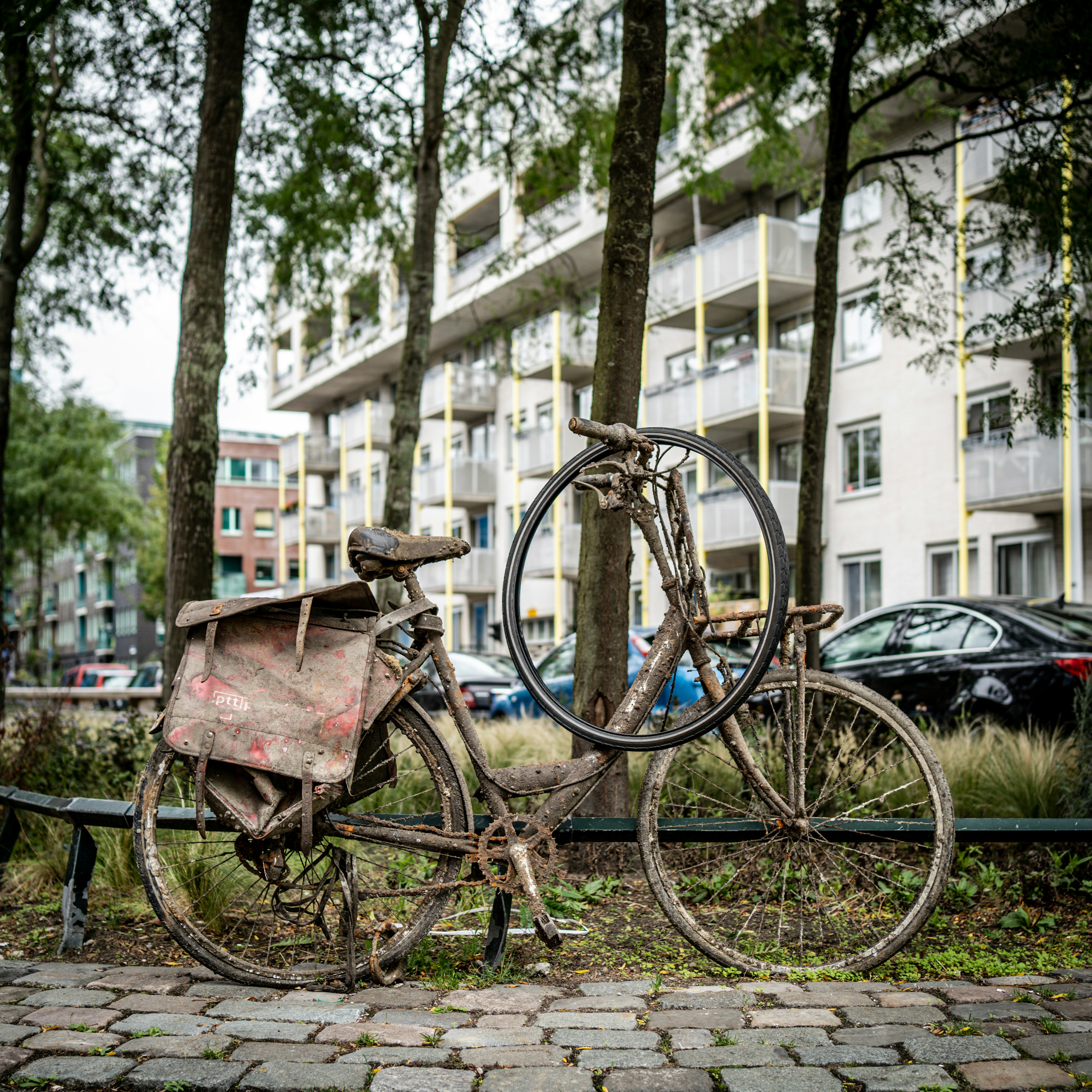 an old bicycle is parked on the side of the road