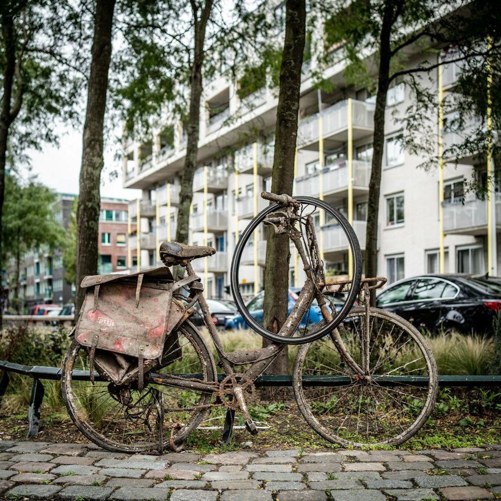 an old bicycle is parked on the side of the road