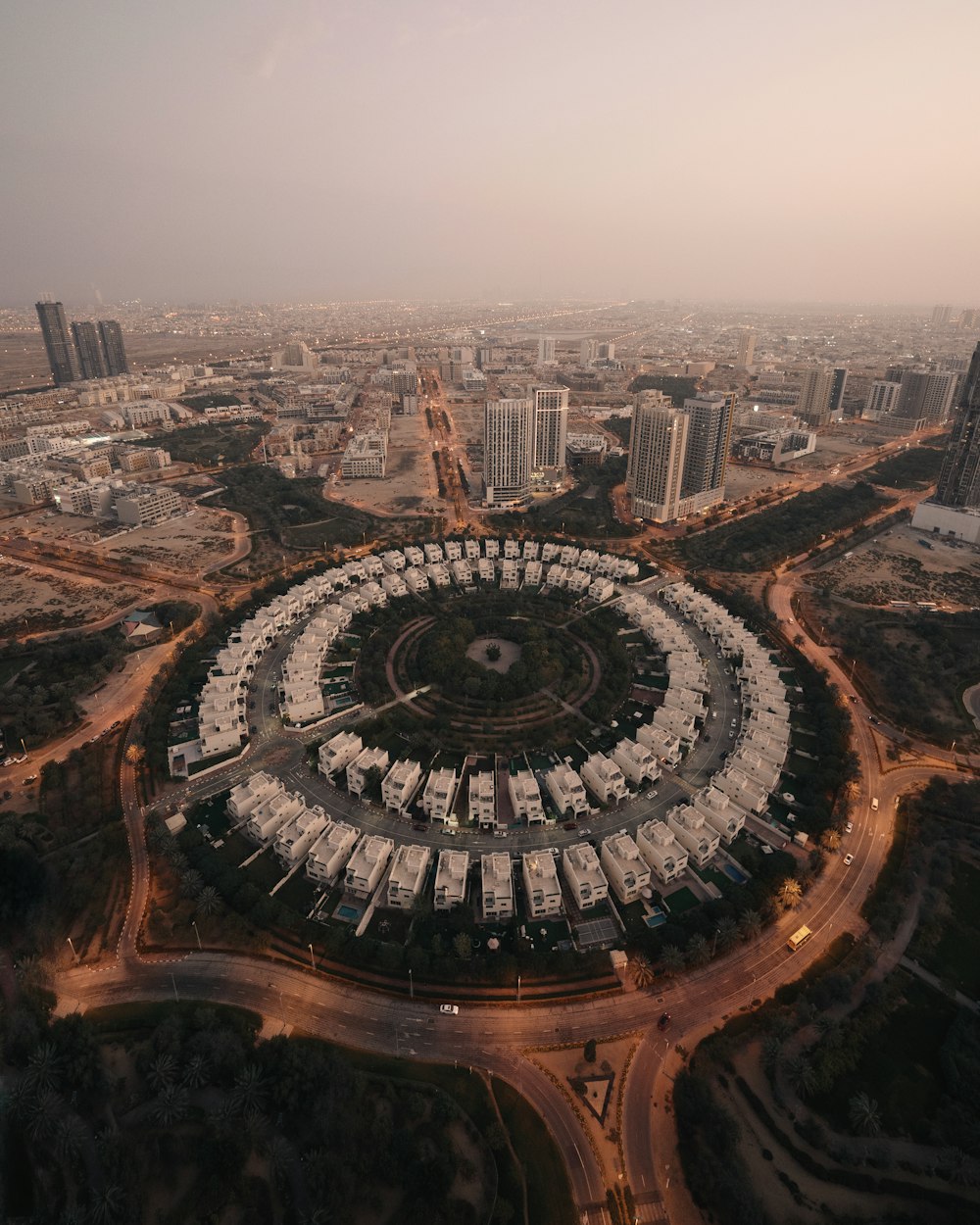 an aerial view of a city with a circular building