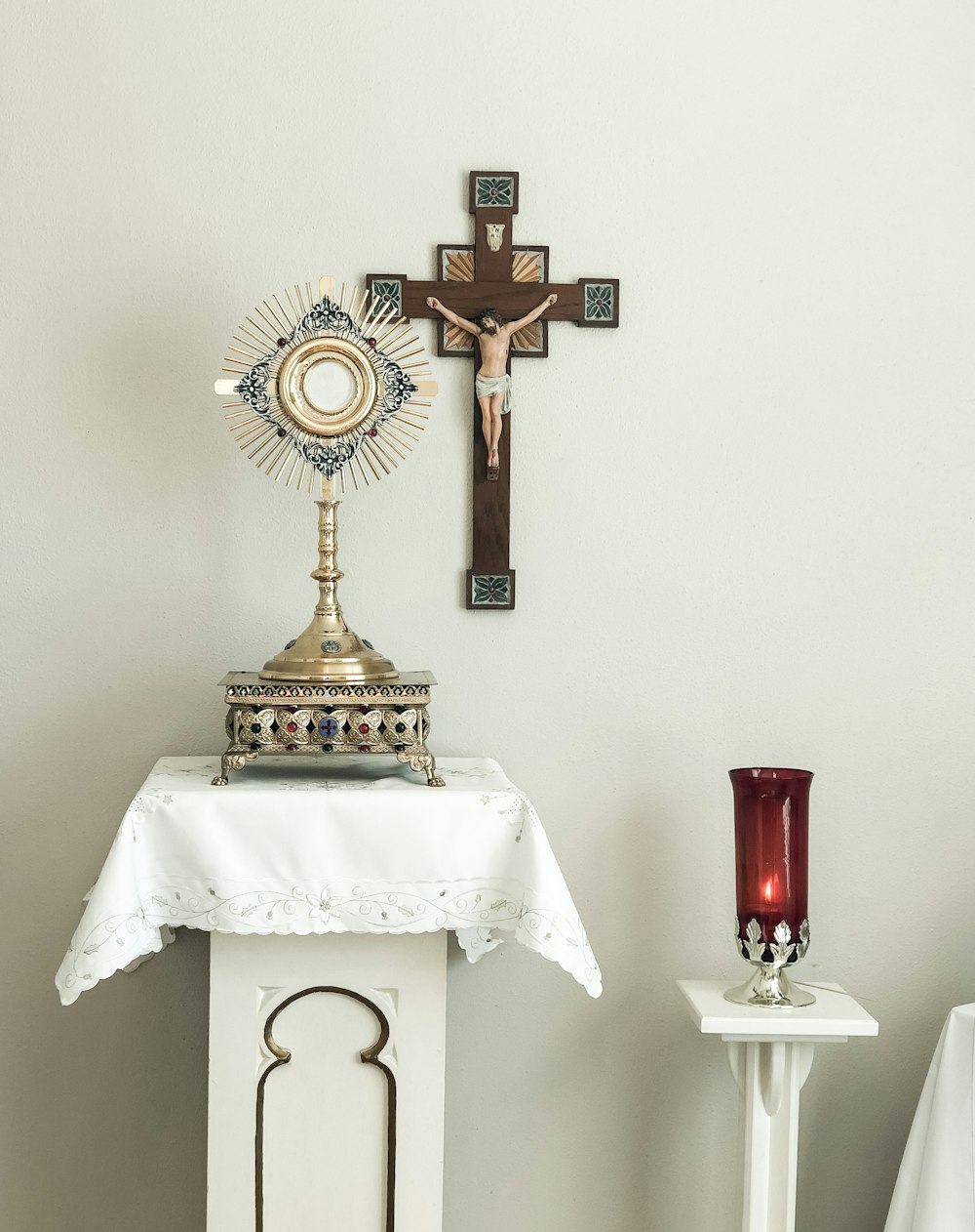 a table with a cross and a candle on it