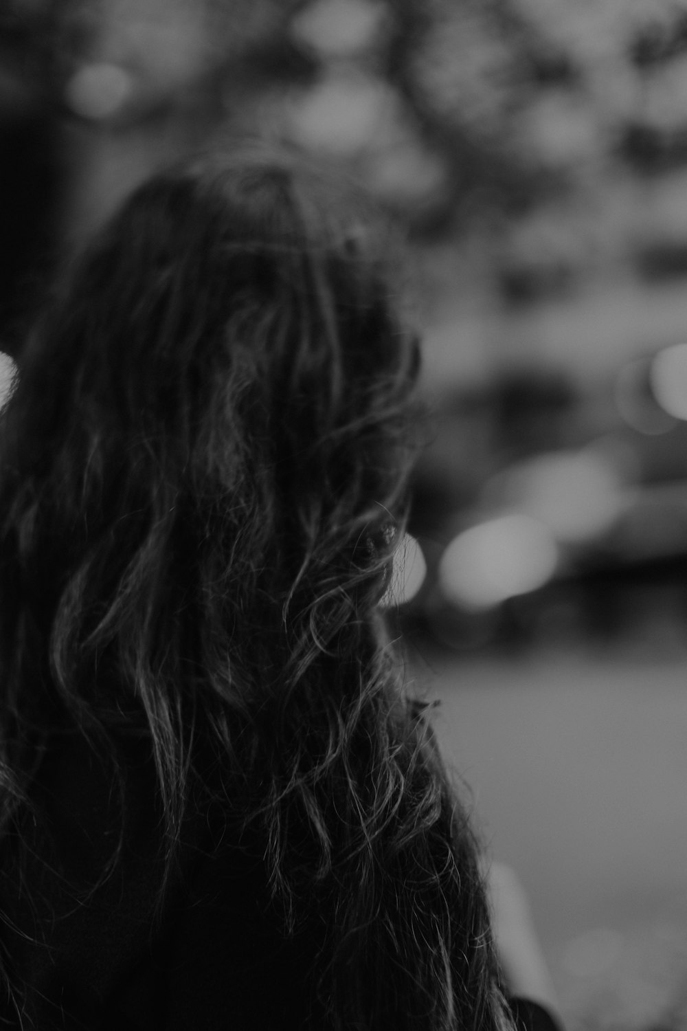 a black and white photo of a woman with long hair