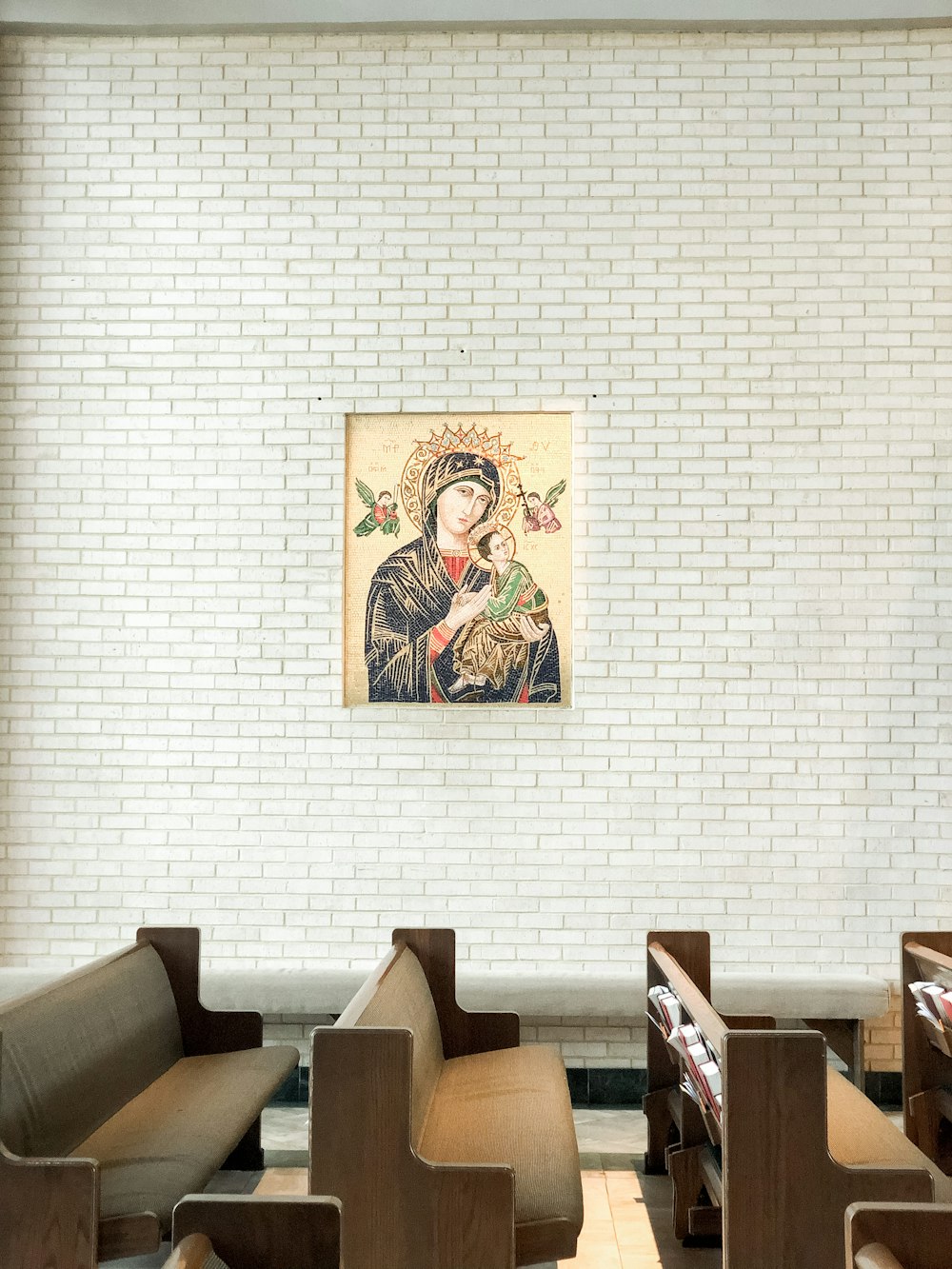 a white brick wall with a painting on it